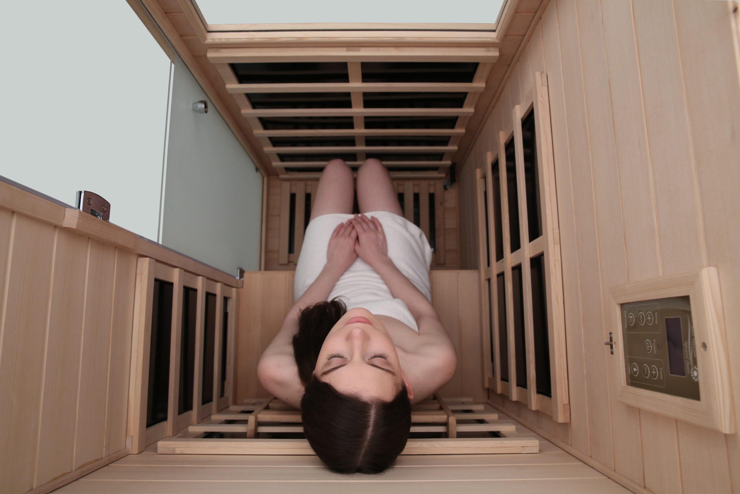 Top inside view with woman inside of Mini Small 1 person infrared sauna